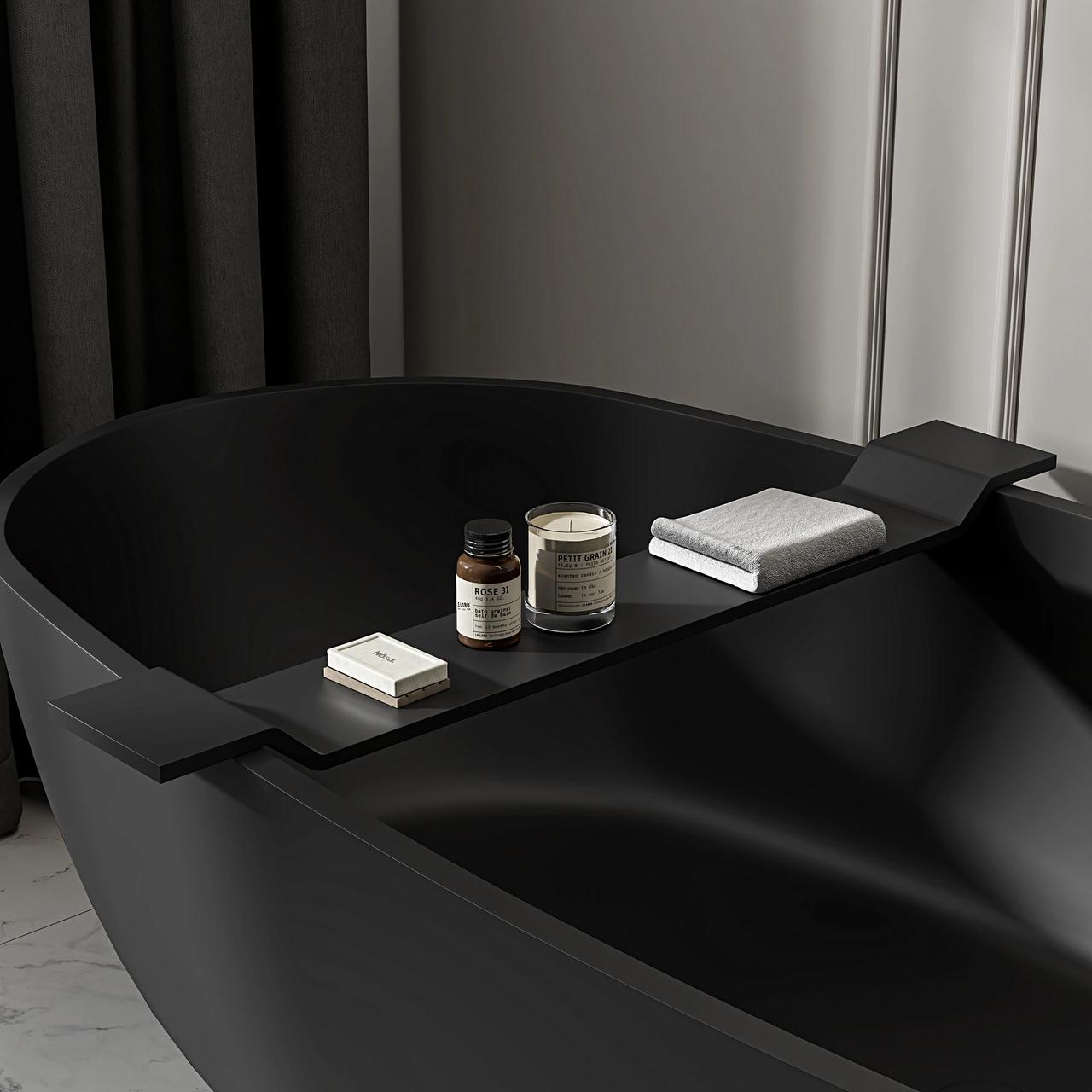 A moody close-up of a matte black freestanding bathtub with a matching bath tray holding spa accessories, showcasing high-end 3d product rendering.
