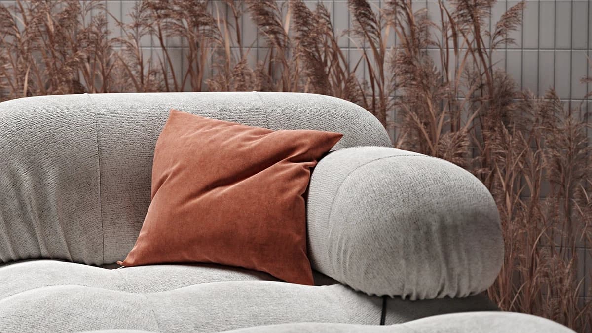 Close-up 3D visual showcasing realistic fabric texture of a grey sofa with an orange pillow.