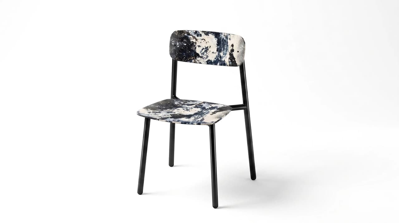Three-quarter view studio render of a modern dining chair with a marble pattern seat and black metal frame.