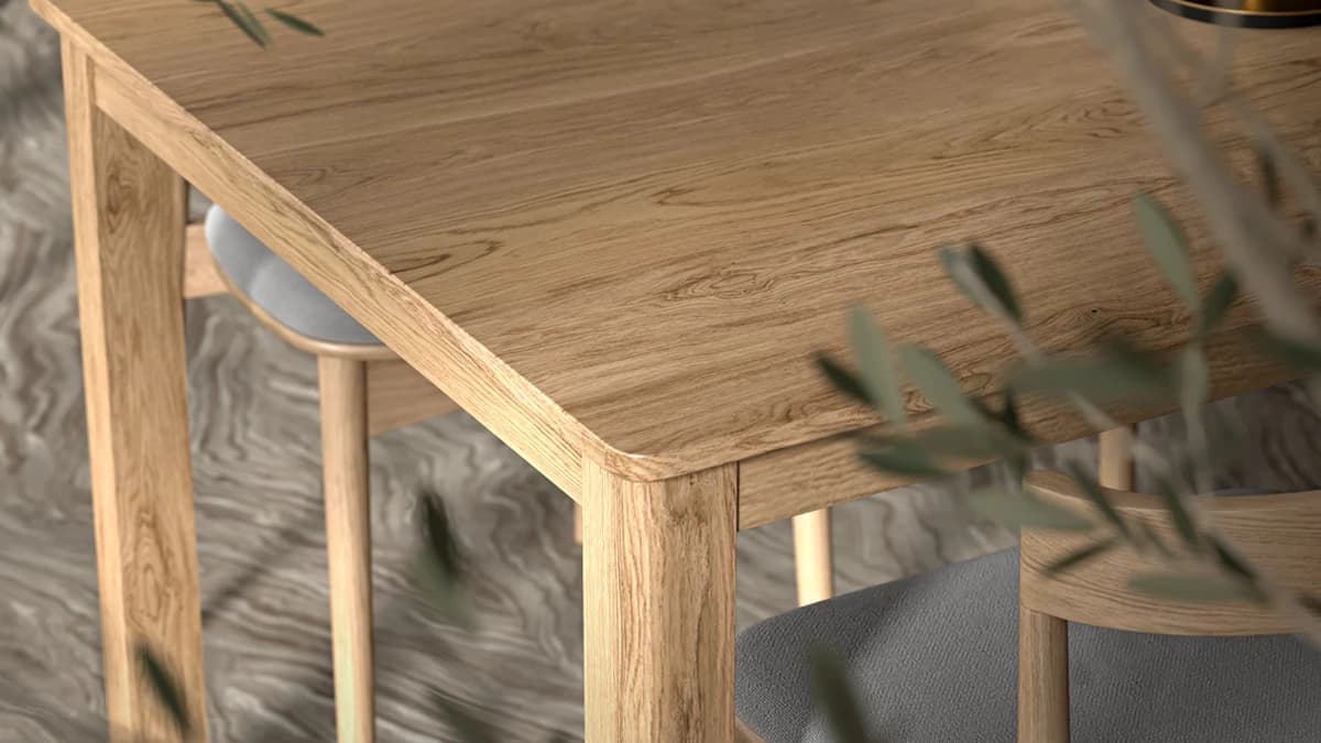 Extreme close-up of a light oak dining table corner, showcasing realistic wood grain and smooth rounded edges in a beautiful 3d table design, framed by soft blurred leaves.