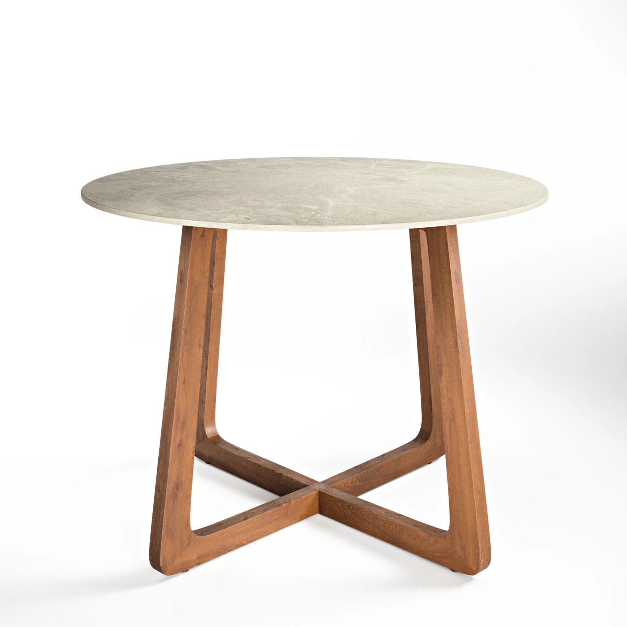 Front view studio render of a round dining table with a stone top and crossed wooden legs base