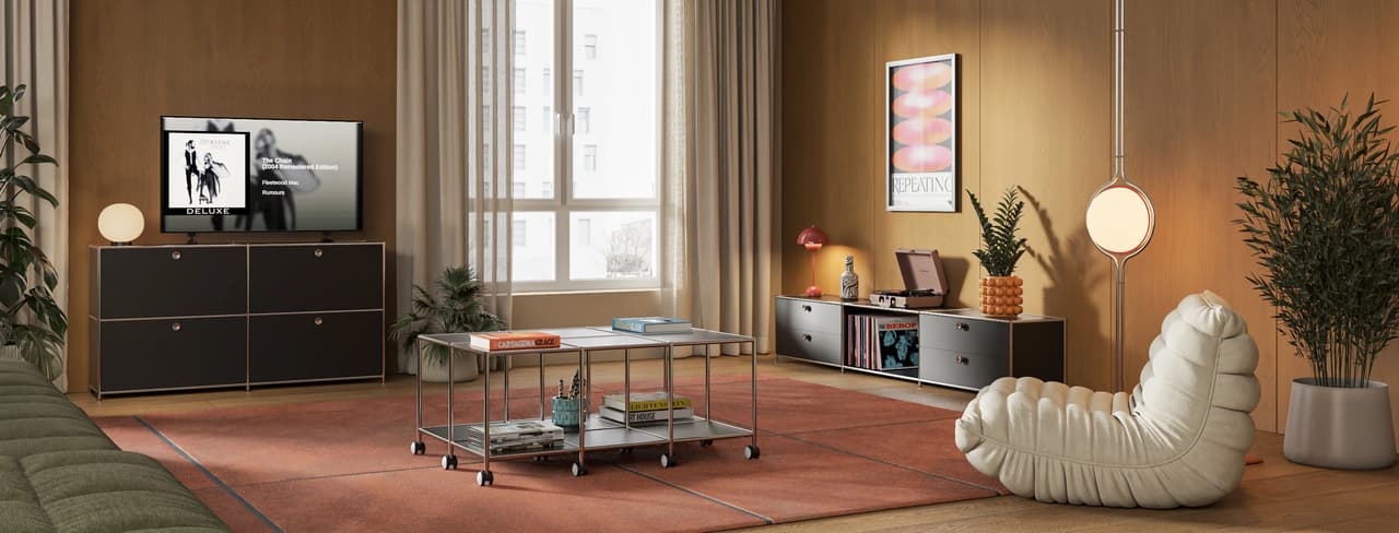 A retro-inspired cgi living room with warm wood-paneled walls and a large terracotta rug. The cozy space features dark grey modular metal cabinets, a glass coffee table on casters, a white ribbed lounge chair, and soft ambient lighting from spherical lamps.