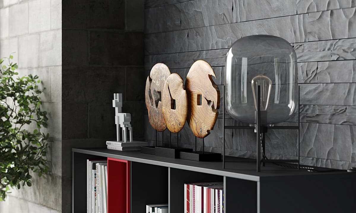 A moody close-up of a modern black 3d console table styled with a smoked glass lamp, wooden disc sculptures, and a white figurine.