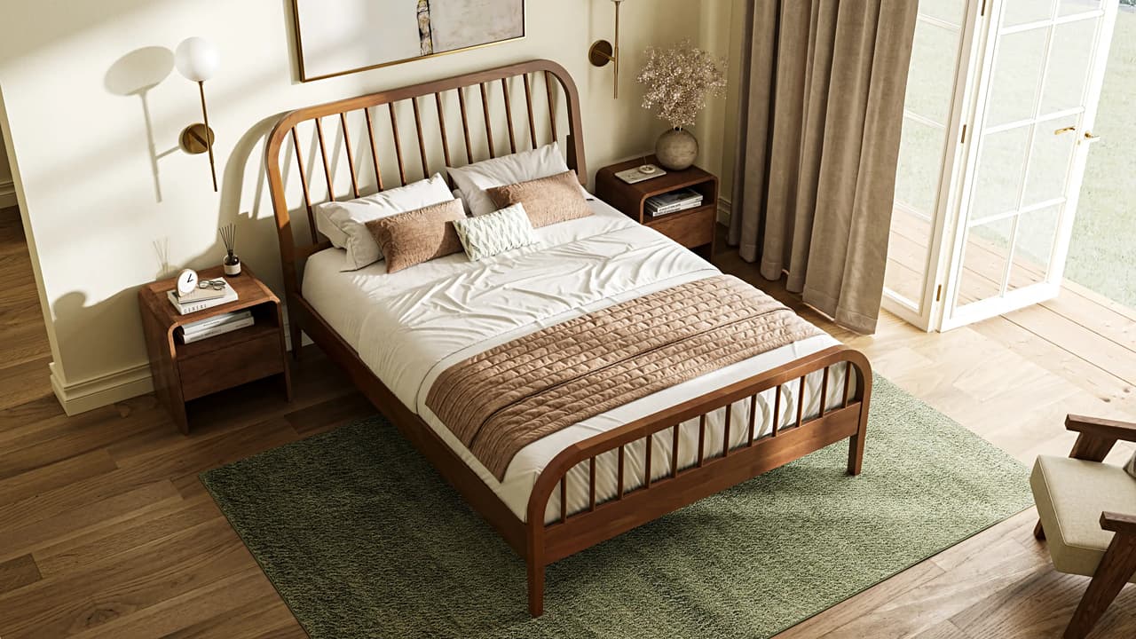 A high-angle shot of a mid-century wooden 3D bed frame with a spindle headboard, set on an olive green rug over hardwood floors. The sunlit bedroom features matching nightstands, white French doors, and warm, natural daylight
