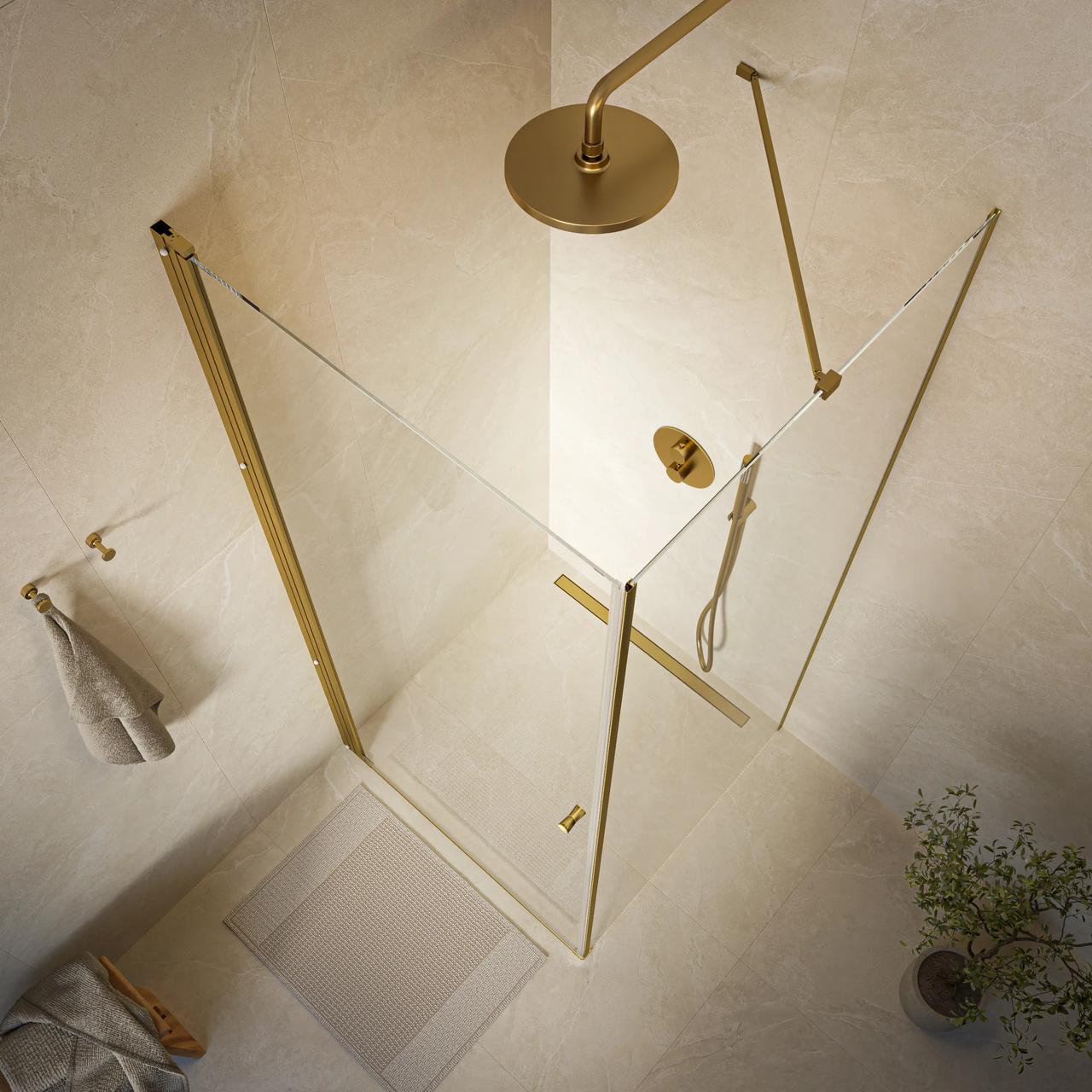 A top-down view of a minimalist walk-in 3d shower featuring clear glass panels and brushed gold fixtures against warm beige textured walls. An overhead rain shower, a matching support bar, and soft neutral towels complete the modern scene.