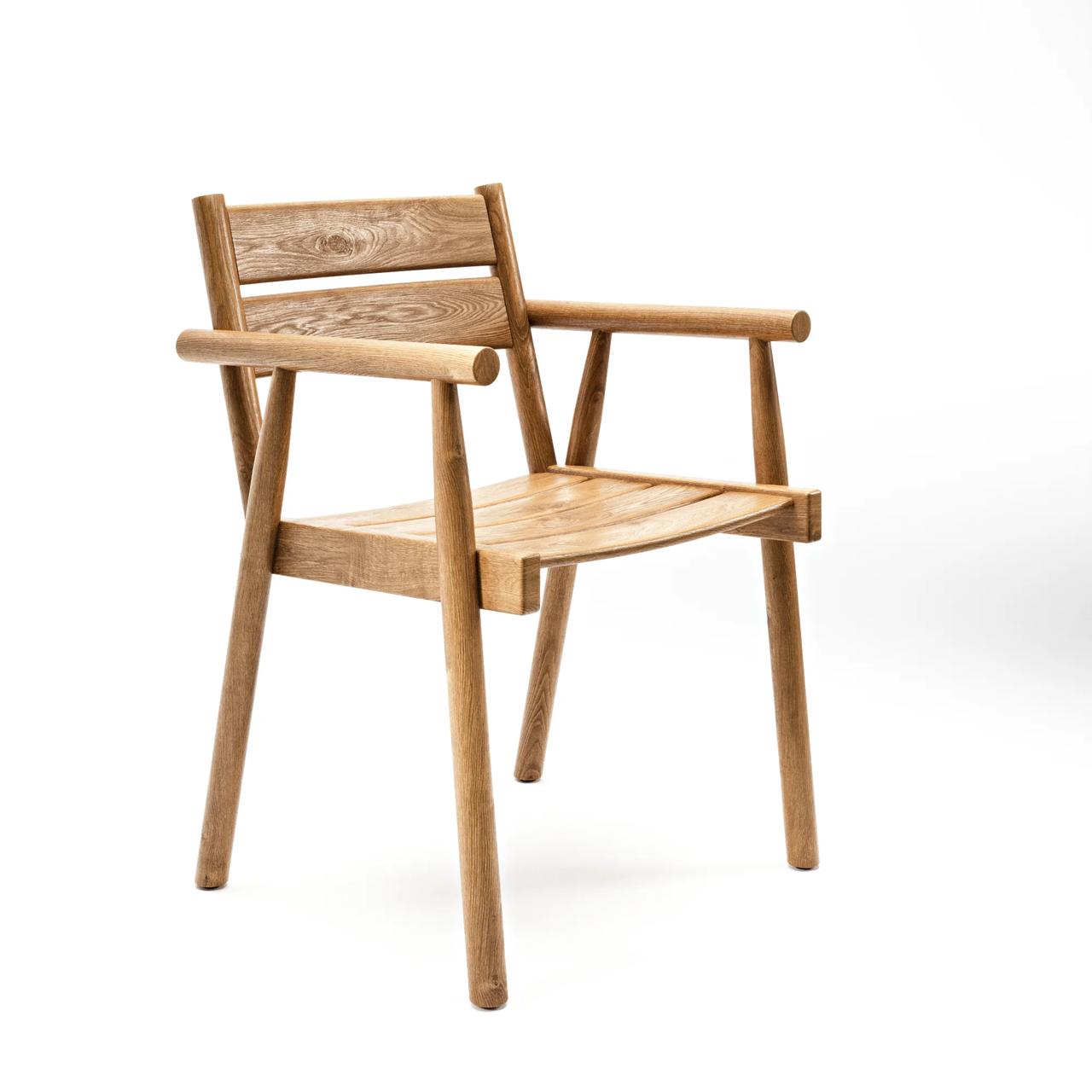 Three-quarter view studio render of a modern wooden armchair showing natural timber grain