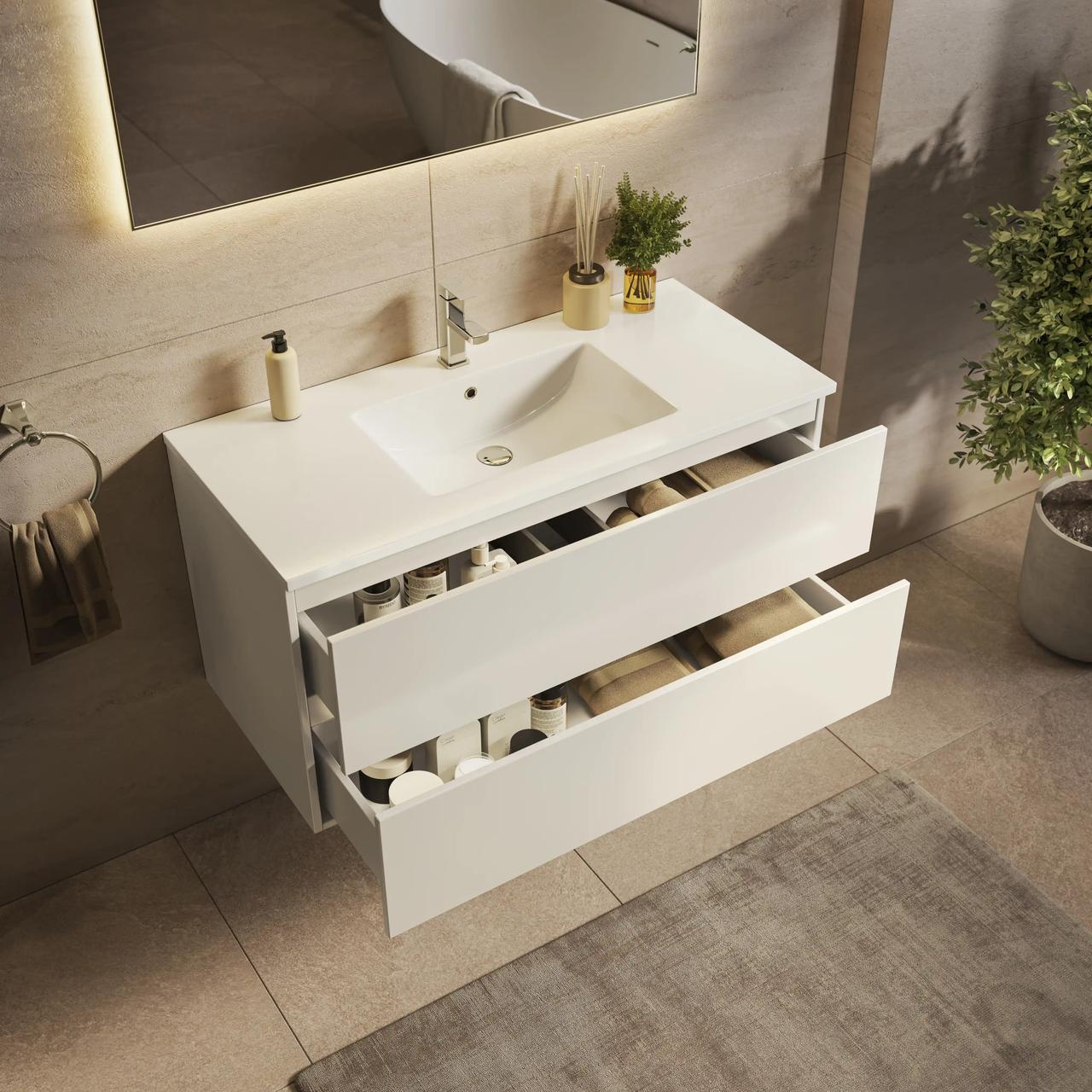 Isometric view of a floating white bathroom vanity with two open drawers showing organized towel storage, an integrated rectangular sink, and an illuminated mirror