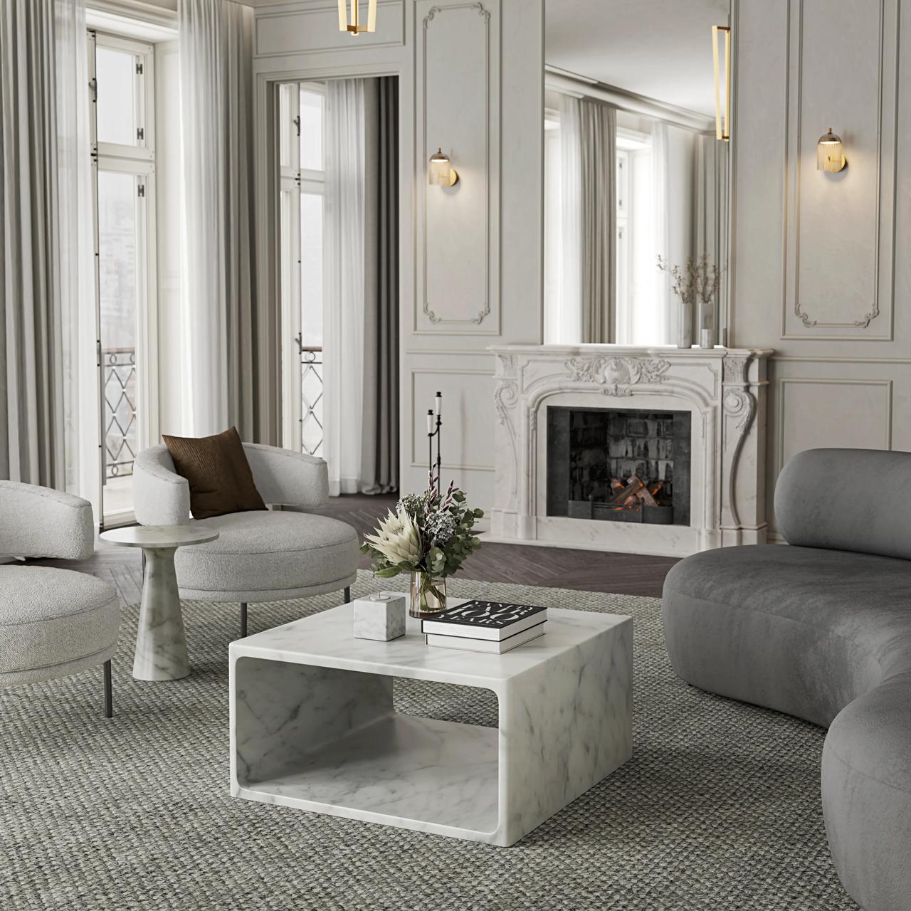 A detailed view of a luxurious modern classic cgi living room, featuring a square white marble Allegro coffee table with an open shelf, set on a textured rug. The table holds a vase and books, surrounded by a curved grey sofa, two white armchairs, and a large ornate stone fireplace with a mirror above it, all set against walls with elegant moldings.