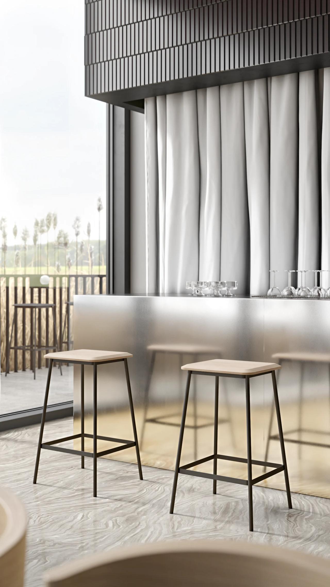 A bright cafe exterior bathed in natural light, with a stainless steel bar counter and minimalist seating.
