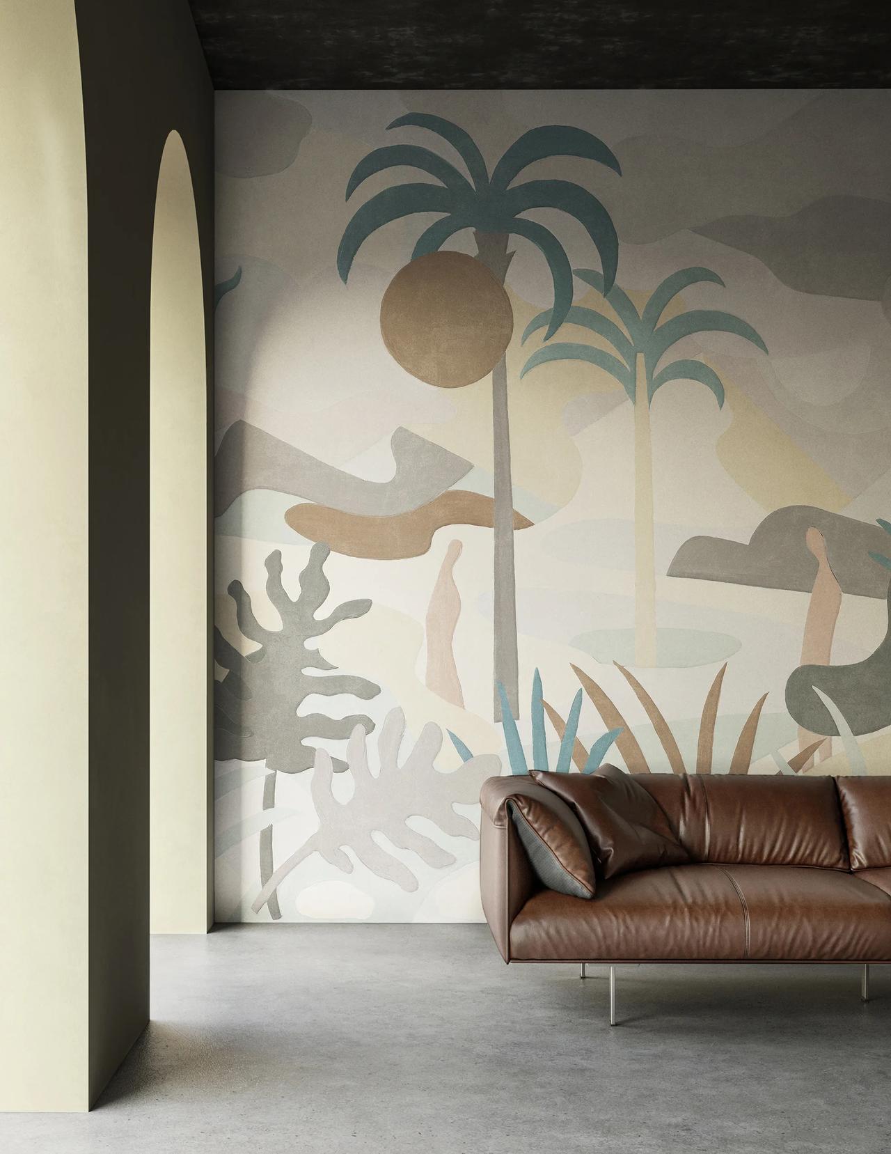 A spacious 3d room featuring a large abstract wall mural with palm trees and tropical leaves in muted earth tones. A minimalist brown leather sofa sits on a concrete floor in front of the art wall, framed by elegant arched doorways on the left.
