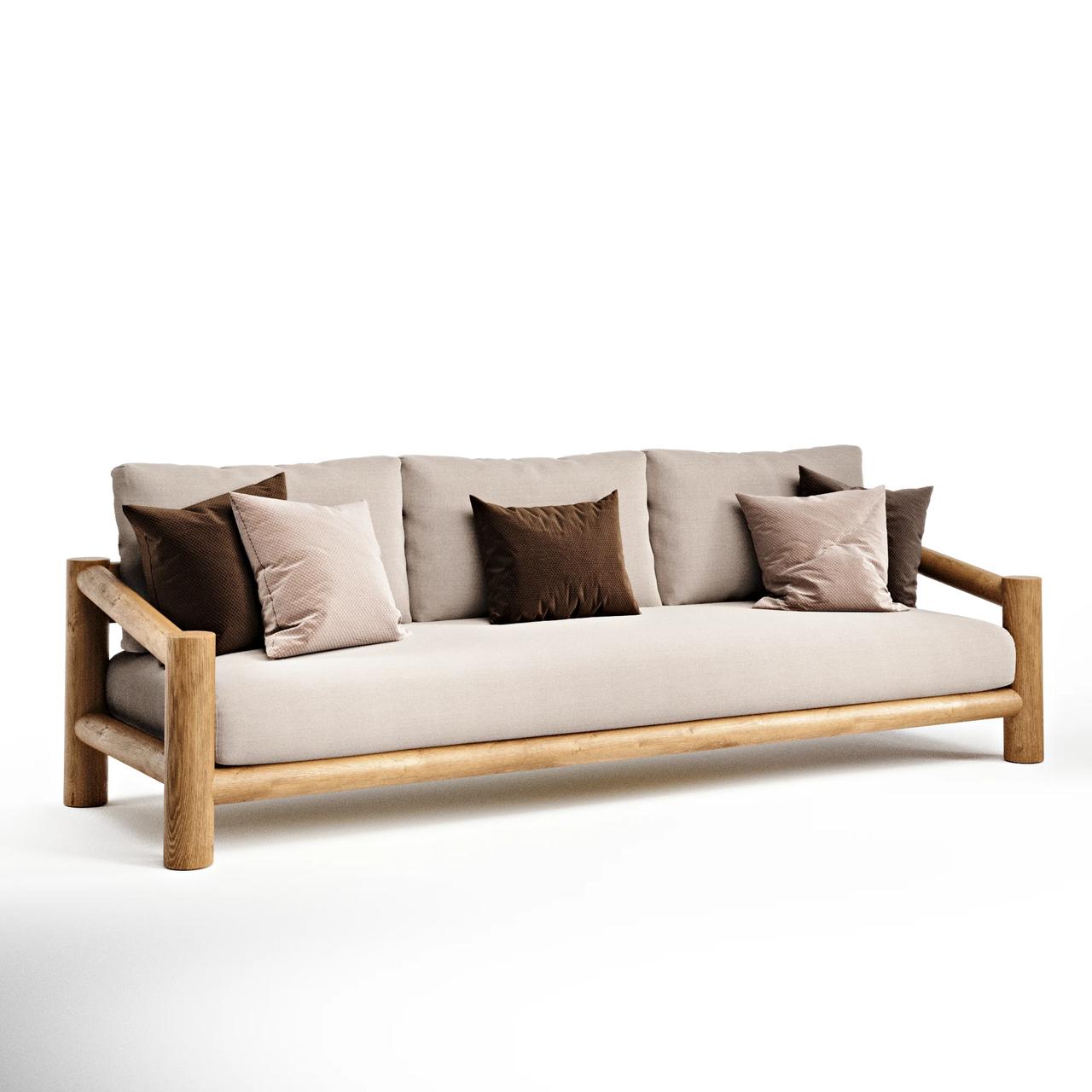 An isolated 3D product render of a 3-seater teak outdoor sofa featuring thick rounded wooden legs and armrests. The sofa is neatly styled with cream seat cushions and decorative brown pillows against a solid white background.