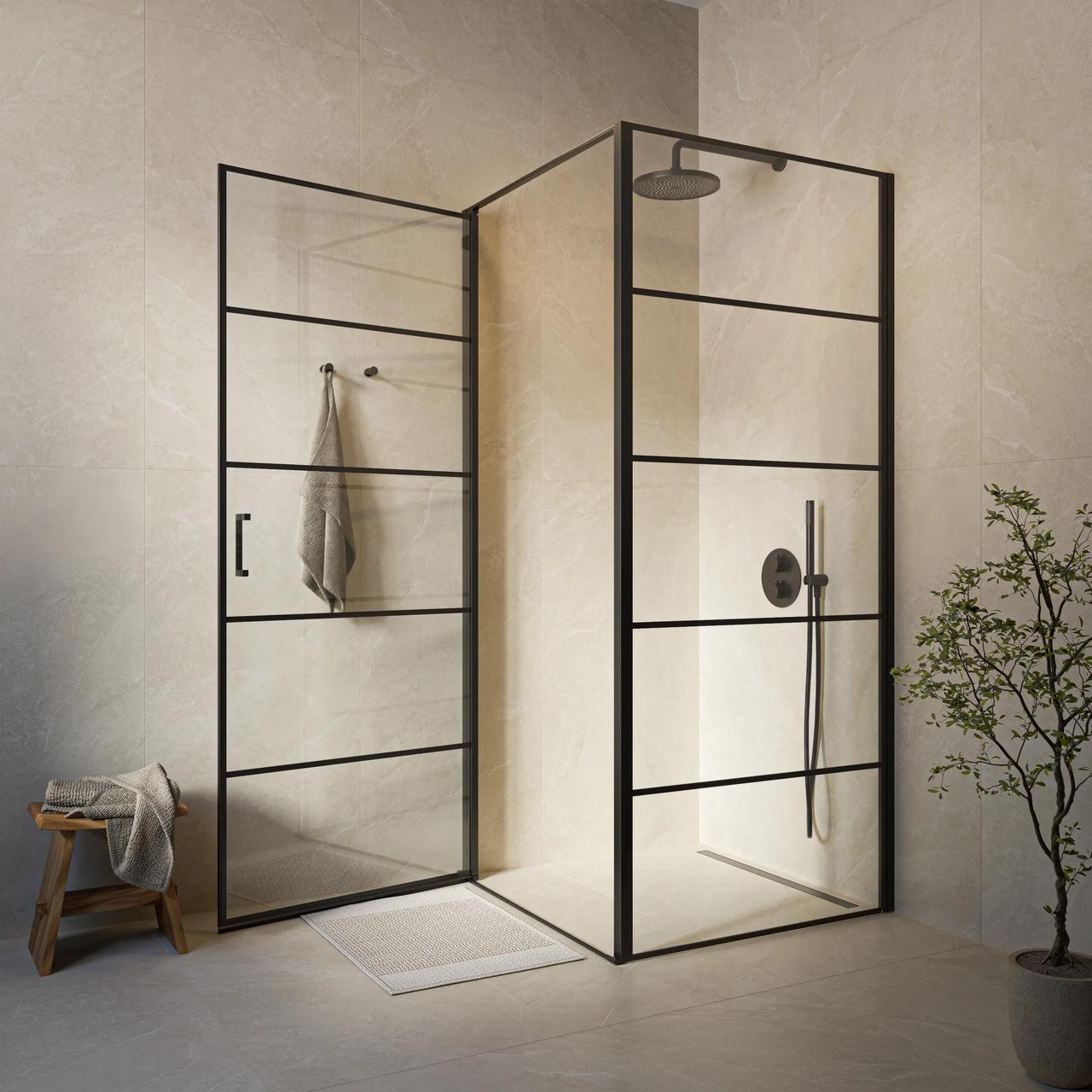 Modern industrial-style shower enclosure with a black metal grid frame, transparent glass doors, and a matte black shower set against light stone tiles