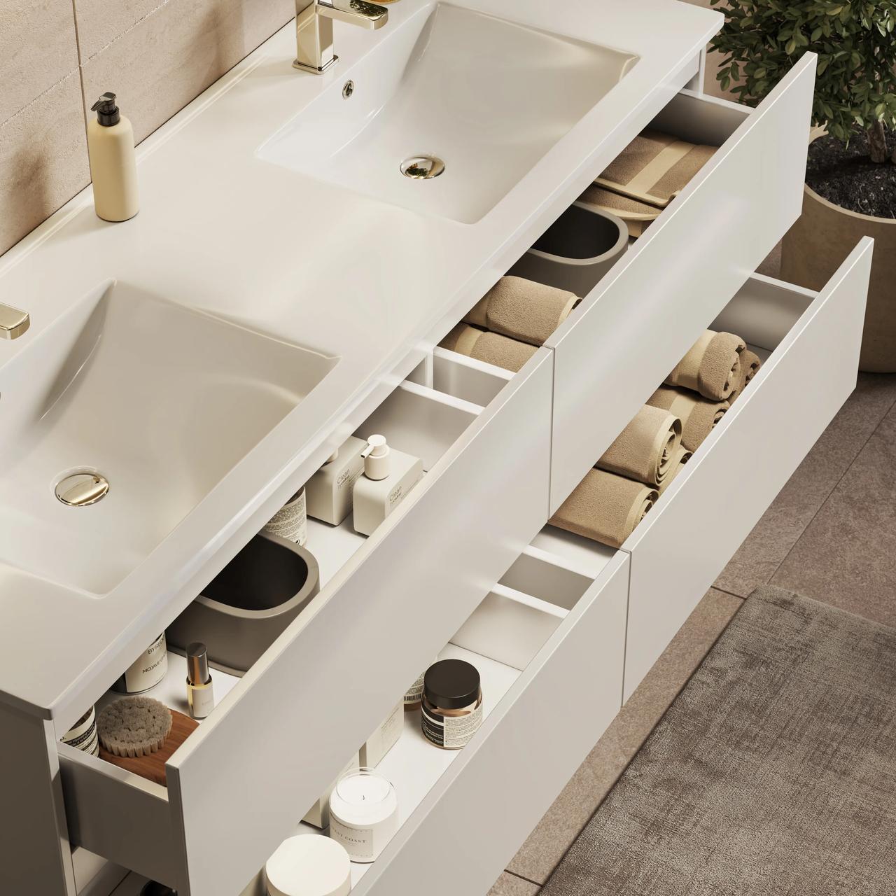 Top-angle view of a large white double-basin bathroom vanity with all four drawers open, showing organized internal compartments, towels, and bath products
