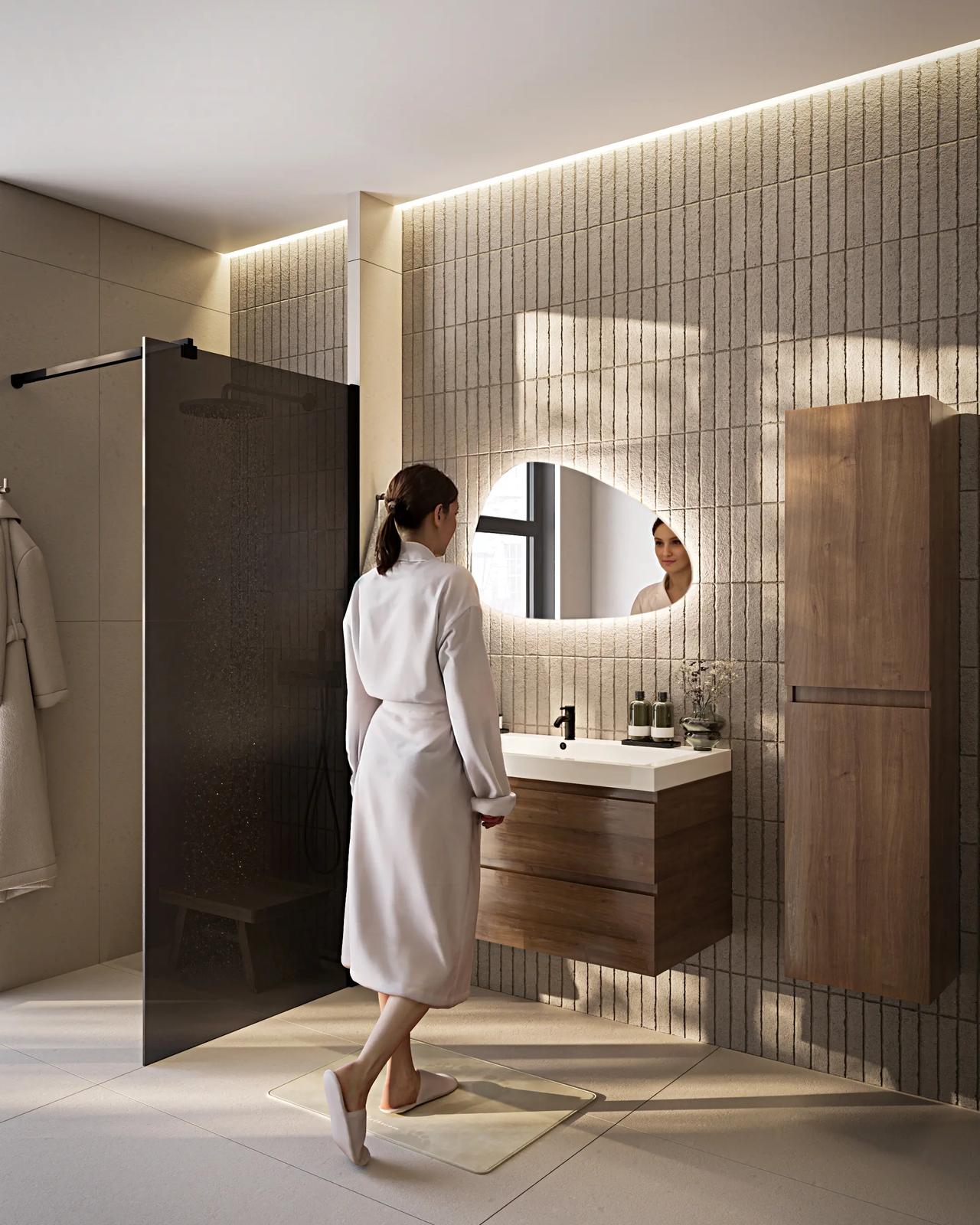 AI woman in a white bathrobe standing in a modern 3D bathroom featuring vertical tiled walls, a floating wooden vanity, an illuminated mirror, and a glass shower cabin