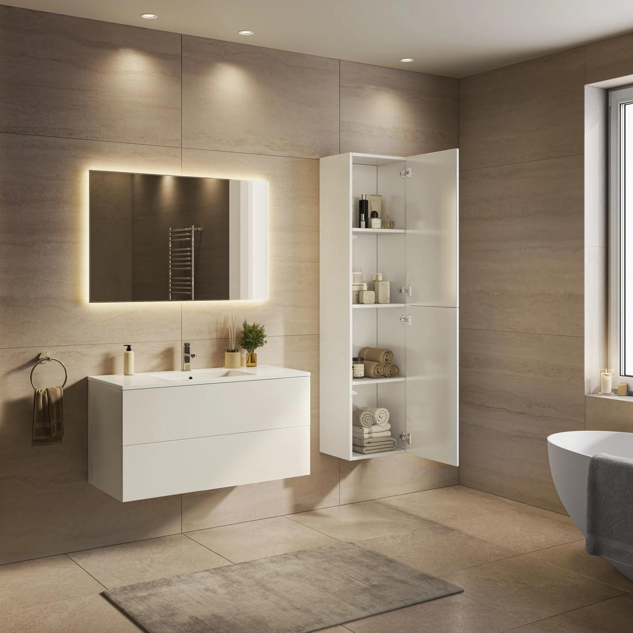 Minimalist bathroom interior featuring a floating white vanity with a rectangular illuminated mirror, an open white tall cabinet, and light beige tile walls