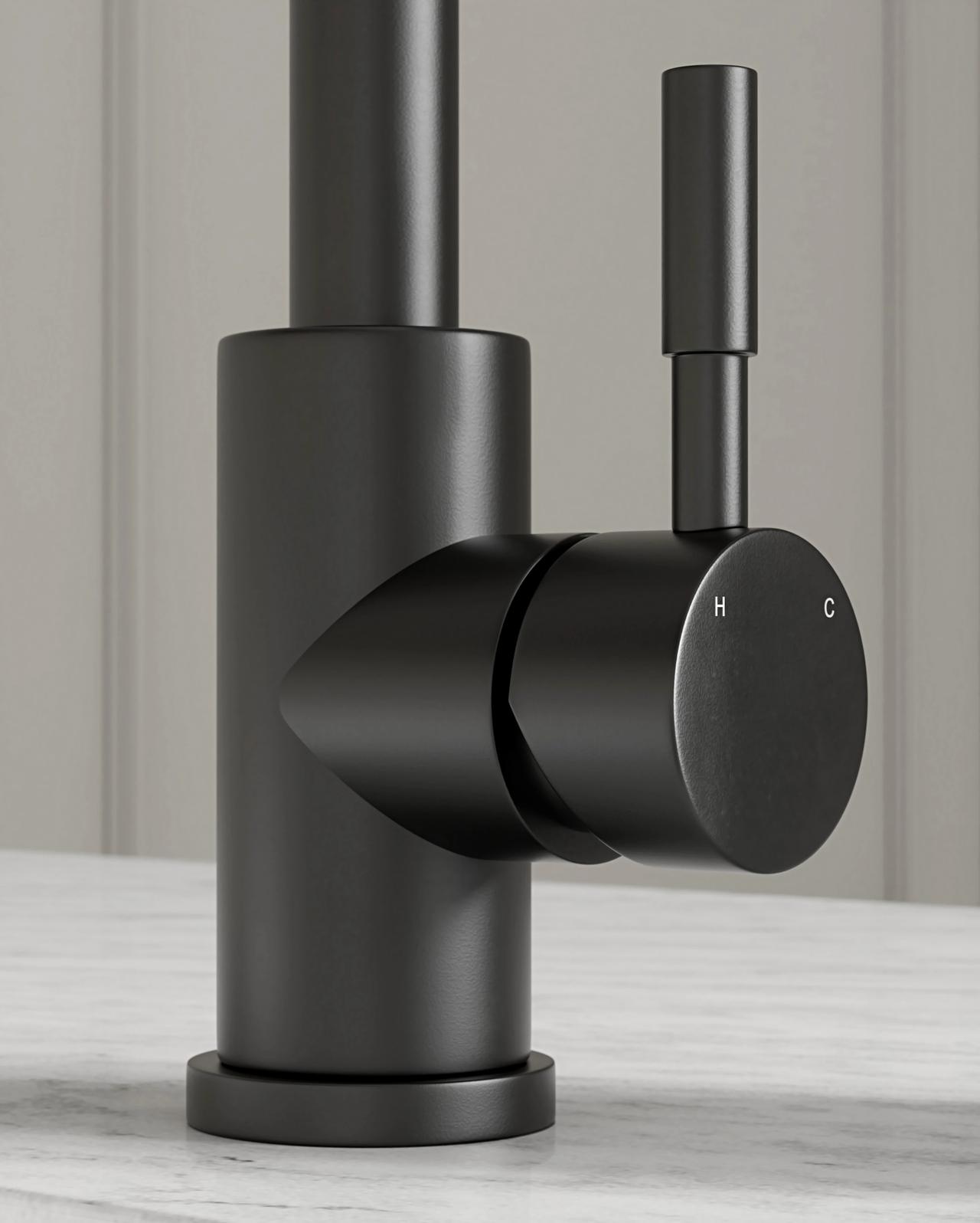 A detailed close-up of a modern matte black cylindrical 3d faucet on a white marble surface. The shot highlights the single side lever with subtle 'H' and 'C' temperature engravings against a softly blurred light grey background.