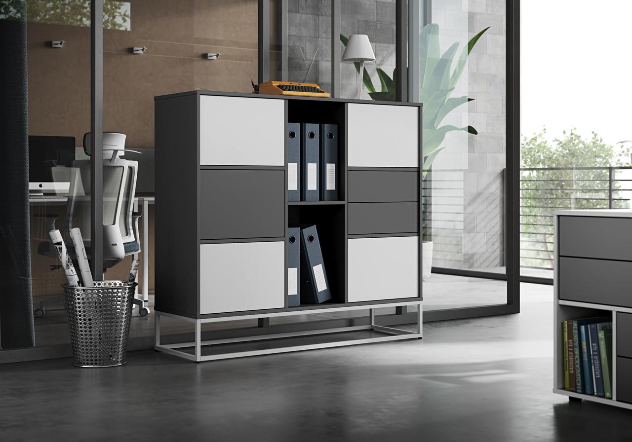 A detailed shot of a contemporary 3d office storage unit with alternating white and dark grey doors and open shelving. The cabinet sits on a white metal base in a modern workspace with glass partitions and office chairs visible in the background.