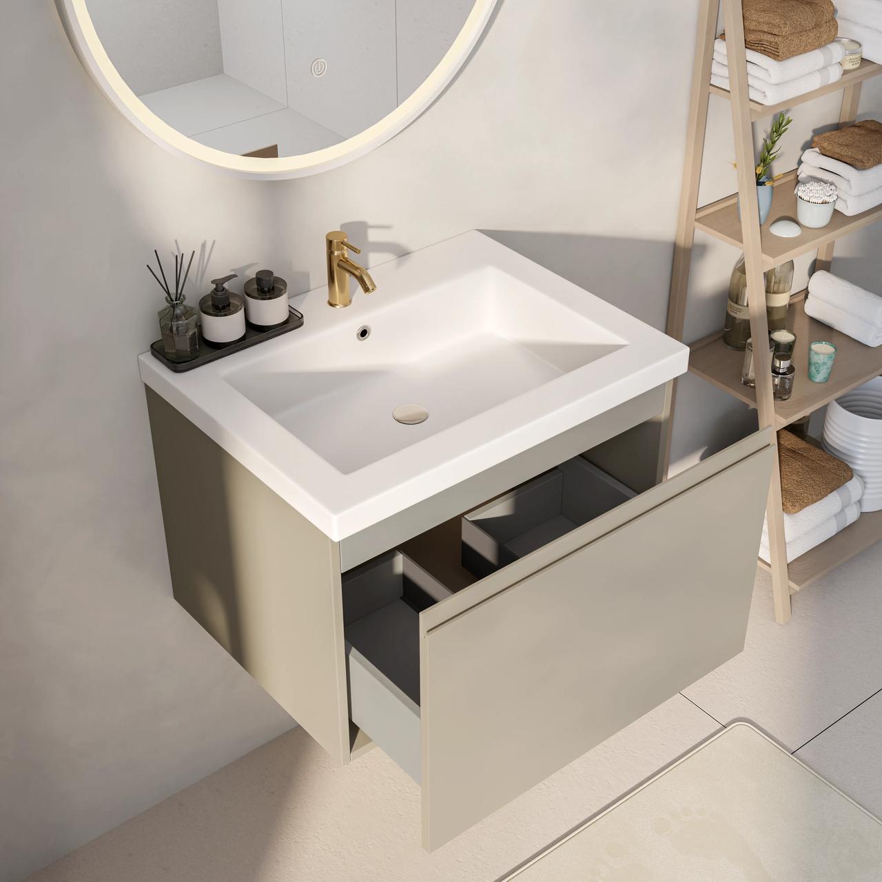 Top-angle view of a compact modern bathroom vanity with an open drawer, integrated white rectangular basin, brass faucet, and round illuminated mirror