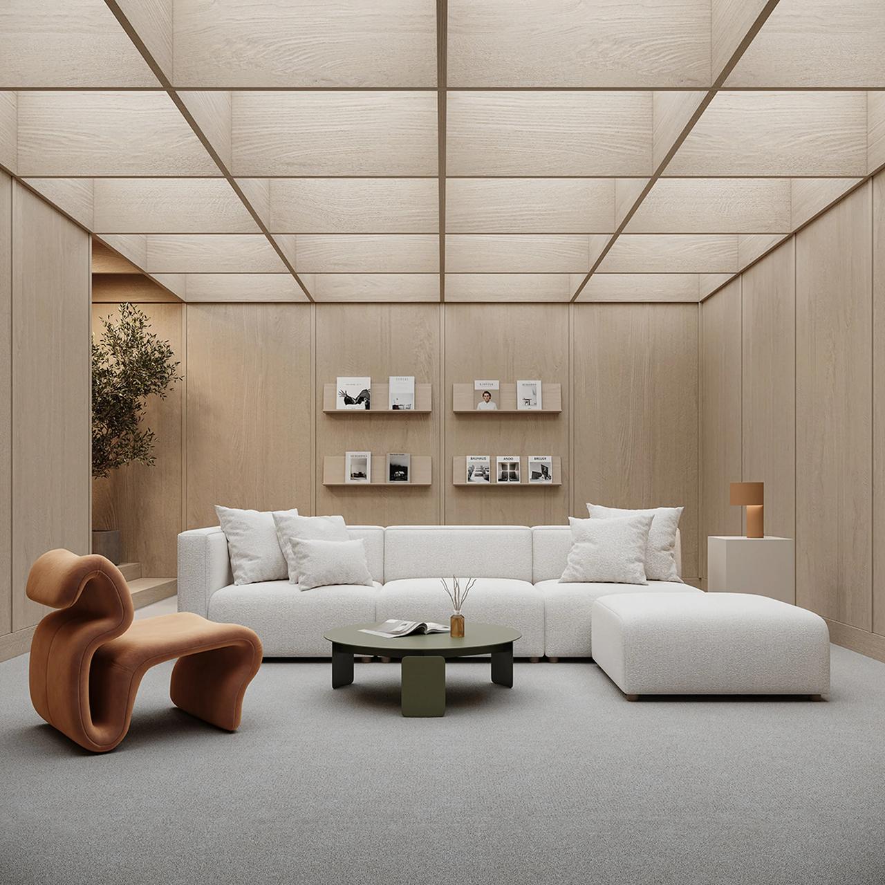 A minimalist, modern 3d lounge area illuminated by a large glowing grid ceiling. The walls are clad in light wood paneling, with four small floating shelves neatly displaying magazines in the center. The room is furnished with a low-profile white modular sofa, a round olive-green coffee table, and a distinctive S-shaped sculptural terracotta lounge chair in the foreground. A hallway with a potted olive tree is visible in the background to the left.