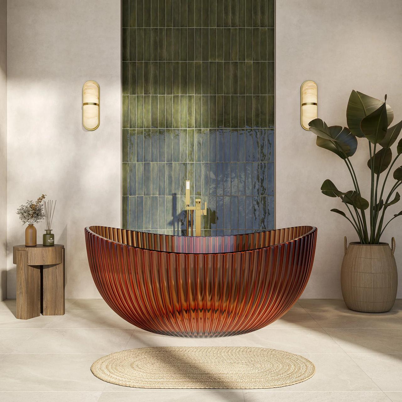 A striking translucent amber ribbed cgi bathtub rests on an oval woven rug in a sunlit modern bathroom. The background features a vertical accent wall of green tiles, brass wall sconces, and a large potted tropical plant.